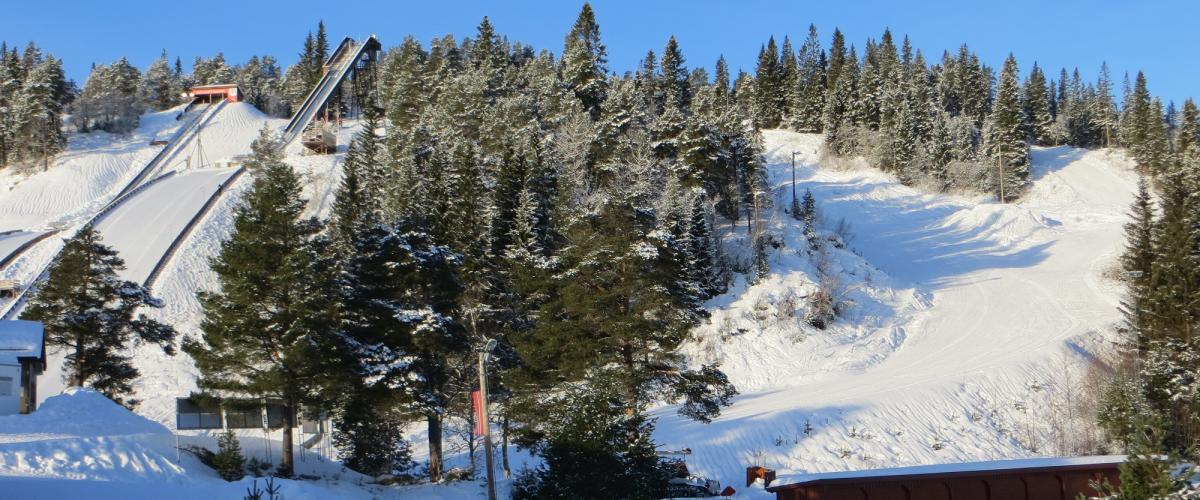 Smal alpinbakke kommer ned på siden av hoppbakkene