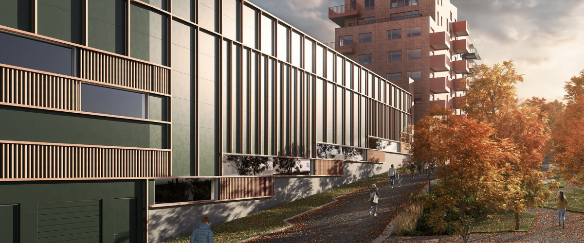 Bilde som viser ThonHallen fra utsiden, der man ser den grønne fasaten med et menneske gående forbi.