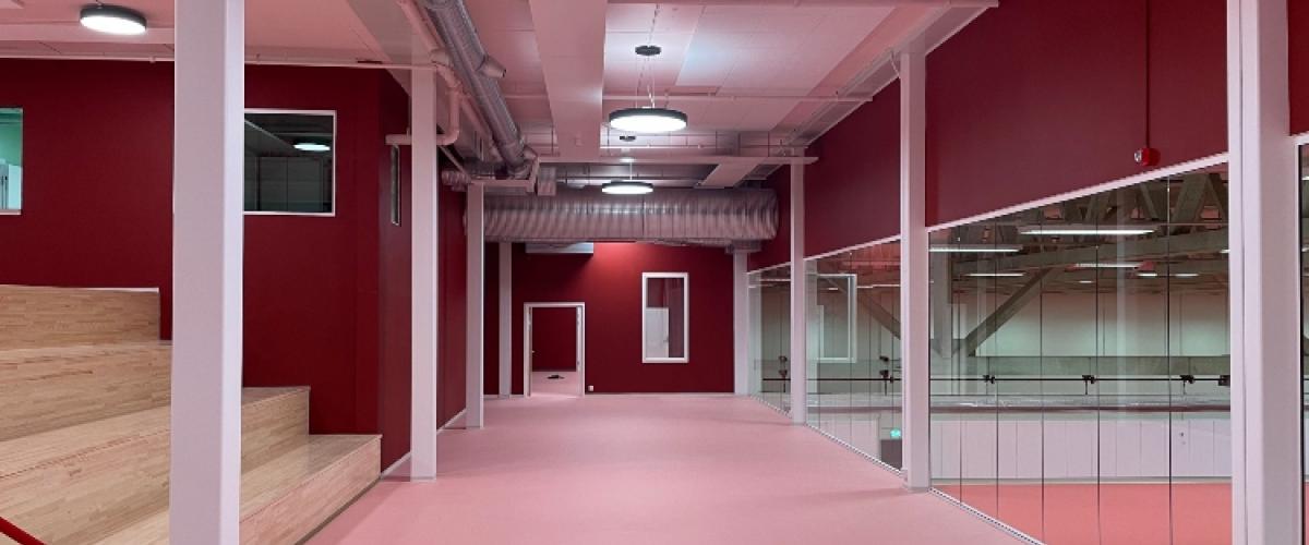 Bilde av foajeen, med lyserosa gulv og røde vegger